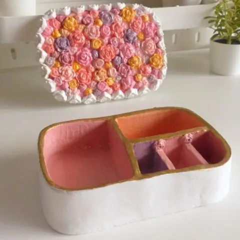 Floral jewelry box open showing multiple storage compartments