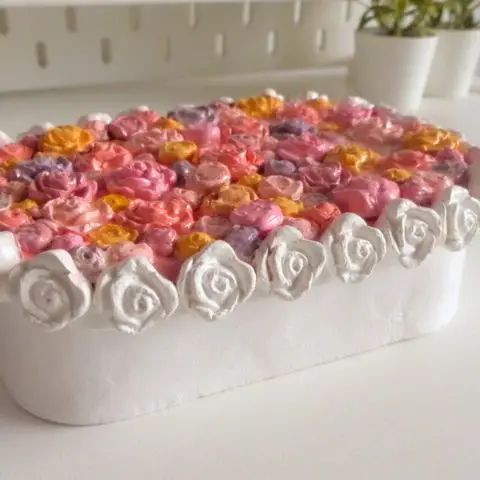 Close up of pink and yellow miniature flowers on floral jewelry box lid